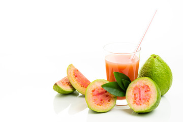 Guava juice and peeled fruit on white background.
