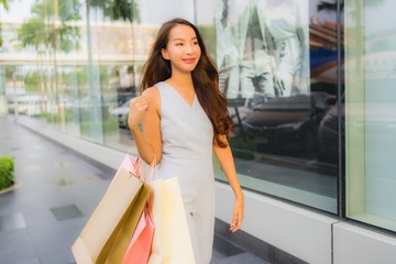 Portrait beautiful young asian woman happy and smile with shopping bag from department store
