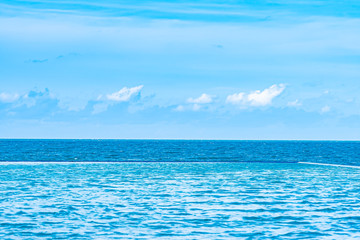 Obraz premium Beautiful outdoor swimming pool in hotel resort with white cloud and blue sky for leisure relax