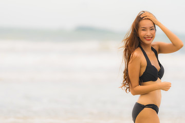 Portrait beautiful young asian woman wear bikini on the beach sea ocean