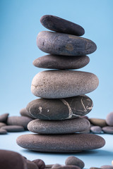 Stack balance of pebbles calm therapy on blue background