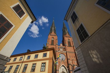 Fototapeta na wymiar Beautiful view on cathedral church between old buildings on blue sky background. Europe.Sweden. Uppsala