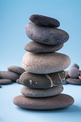 Stack balance of pebbles calm therapy on blue background