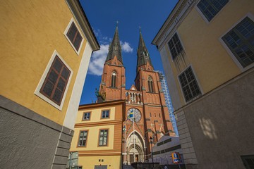 Obraz premium Beautiful view on cathedral church between old buildings on blue sky background. Europe.Sweden. Uppsala