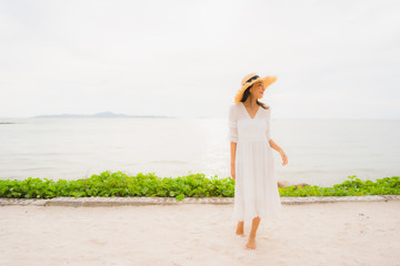 Fototapeta na wymiar Portrait beautiful asian woman wear hat with smile happy leisure on the beach and sea in holiday vacation