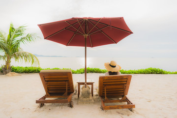 Portrait beautiful asian woman wear hat with smile happy leisure on the beach sea ocean in holiday vacation