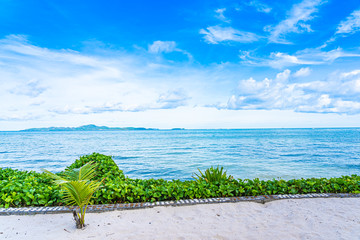 Beautiful landscape of beach sea ocean with coconut palm tree with white cloud and blue sky