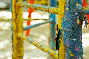 Old painted stairs in the playground close-up on a blurred background. peeling blue and yellow...