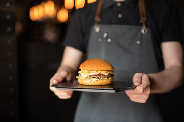 Waiter shot of chef carrying burger for client - 271850849