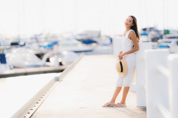 Portrait beautiful young asian woman leisure smile happy relax around yacht port