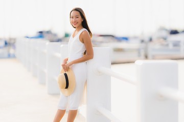 Portrait beautiful young asian woman leisure smile happy relax around yacht port