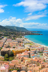 Stunning view of coastal city Cefalu in Sicily, Italy captured on a vertical picture. The city on Tyrrhenian coast surrounded by rocky hills is a popular summer vacation destination