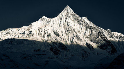 Mountain peaks with glaciers and snow in dark monochrome style, Himalayas