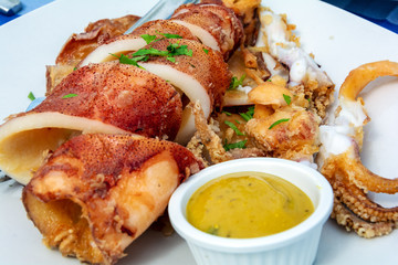 Squid and seafood with close-up sauce in the restaurant