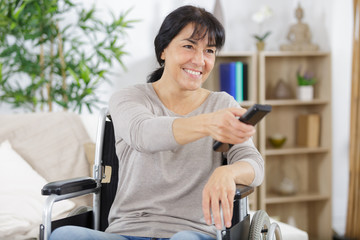 cheerful woman watching television in living room