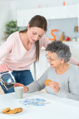 senior woman getting helped with her breakfast