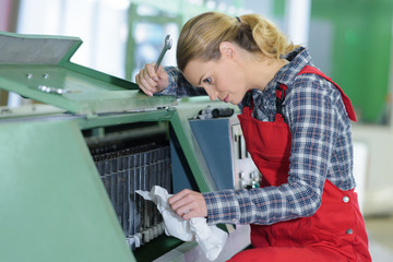 woman fixing cartridge in printer machine at office