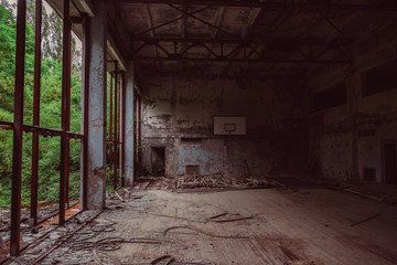 Fototapeta na wymiar Chernobyl Exclusion Zone, Ukraine. School gym in destroyed abandoned ghost city Pripyat ruins after disaster. Fallout lost town, apocalyptic building.