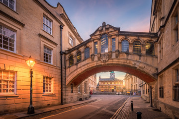 Bridge of sign with the Sheldonian theatre background and street lamp foreground during twilight at...