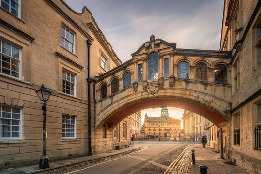 Bridge of sign with the Sheldonian theatre background and street lamp foreground during sunset at Oxford, UK