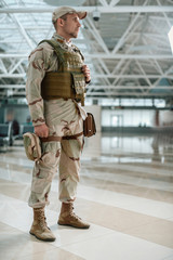 Side view of upset soldier in camouflage looking away