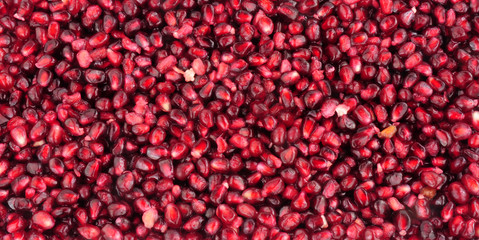 Fresh sweet juicy pomegranate fruit seed background