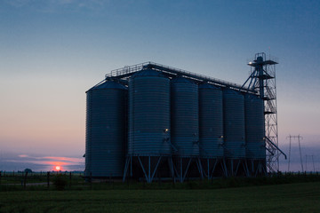 silos for storage of cereals and agricultural products photographed in the sunset © slobodan023