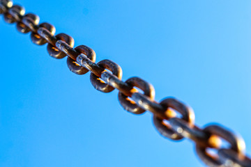 chain on blue sky, diagonal from right to left. 