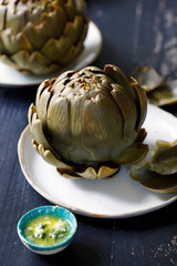 Whole steamed globe artichoke with garlic butter dip