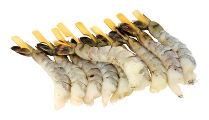 Group of fresh raw black king tiger prawns on wooden skewers isolated on a white background