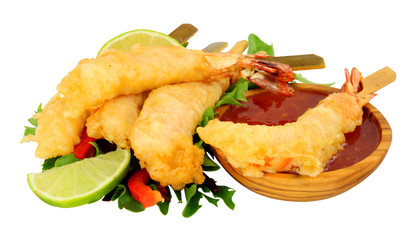 Tempura battered king tiger prawns on wooden skewers with chilli sauce dip isolated on a white background