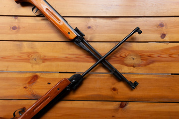 Two rifles laying flat on a table