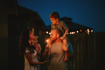 Happy Family doing sparkler fireworks together