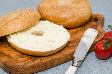 Breakfast sandwich bagel with soft cream cheese and herbs