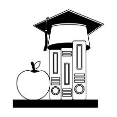 graduation hat on education books and apple