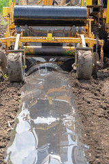 Fototapeta premium Tractor Attachment for Plastic Mulch Bed Laying