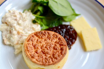 Lunch cheese soufflé with relish, sliced cheddar cheese and salad
