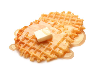 Delicious waffles with butter and honey on white background