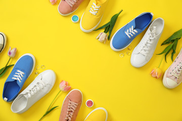 Flat lay composition with different sneakers and accessories on color background, space for text. Trendy spring look