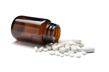 Bottle with vitamin pills on white background