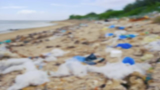 Trash, plastic, garbage, bottle... environmental pollution on the beach. Royalty high-quality free stock blurry footage of trash, plastic bottle on the beach. Waste that polluted the ocean environment