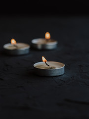 Obraz na płótnie Canvas Burning candles on a black background