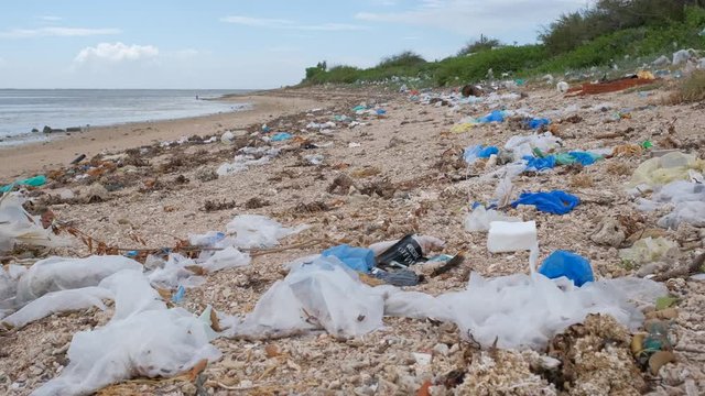 Trash, plastic, garbage, bottle, bag... environmental pollution on sandy beach. Royalty high-quality stock video footage trash, plastic bag, bottle on the beach. Waste that polluted ocean environment