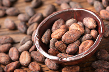 dried cacao beans on the old wooden board