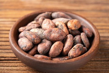 dried cacao beans on the old wooden board