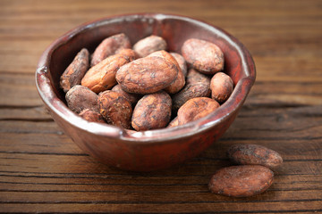dried cacao beans on the old wooden board