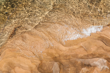 Looking down through the crystal clear waters of Lake Superior  to the sandstone shore on the upper...