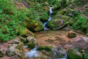Water streaming over rocky cascades along famous Gertelbach waterfalls, Black Forest, Germany