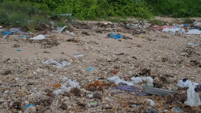 Trash, plastic, garbage, bottle... environmental pollution on the beach. Royalty high-quality free stock photo footage of trash, plastic bottle on the beach. Waste that polluted the ocean environment