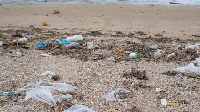 Trash, plastic, garbage, bottle... environmental pollution on the beach. Royalty high-quality free stock photo footage of trash, plastic bottle on the beach. Waste that polluted the ocean environment